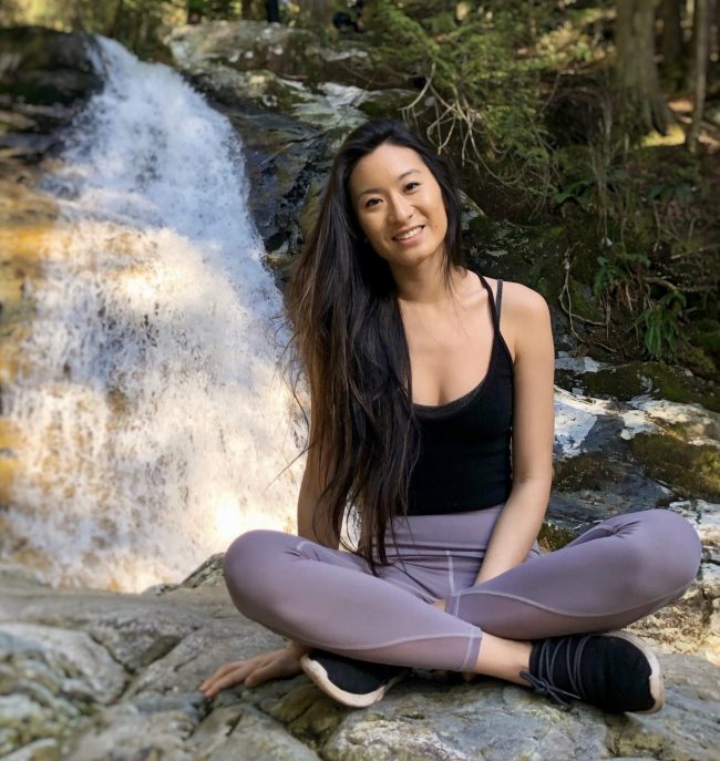 Laura Lu sitting in front of a stream