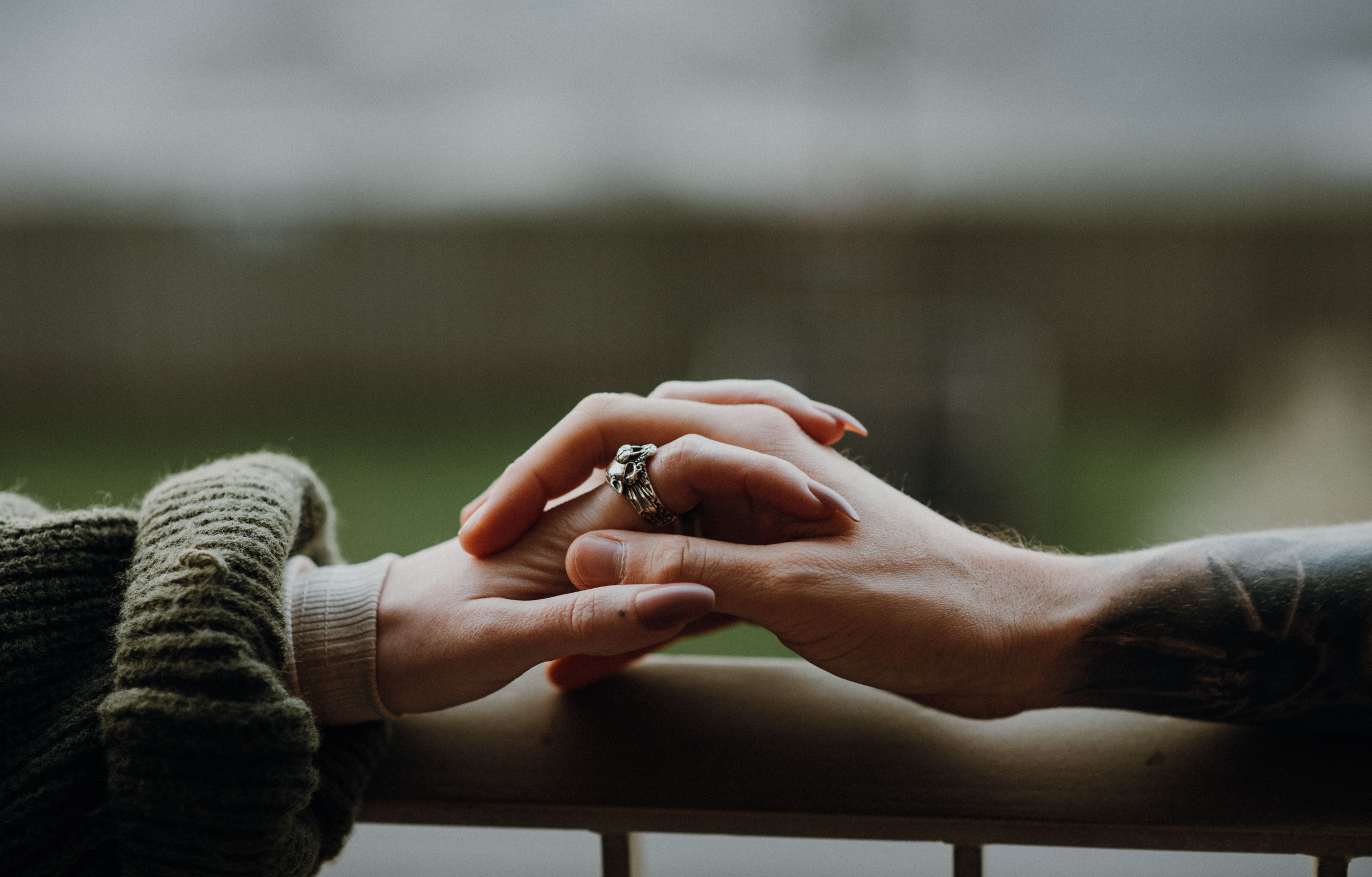 A cozy and welcoming counselling psychotherapy room with plush sofas, personal touches on the walls in form of photos, and ample natural light streaming in through large windows.
